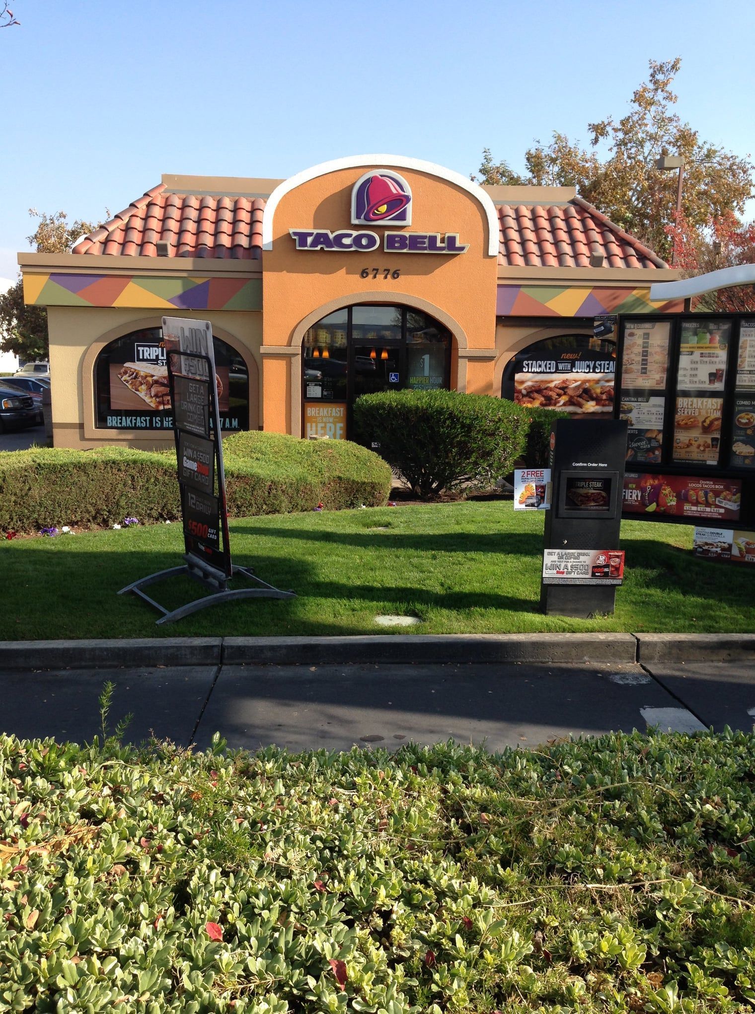A taco bell restaurant with a sign in front of it