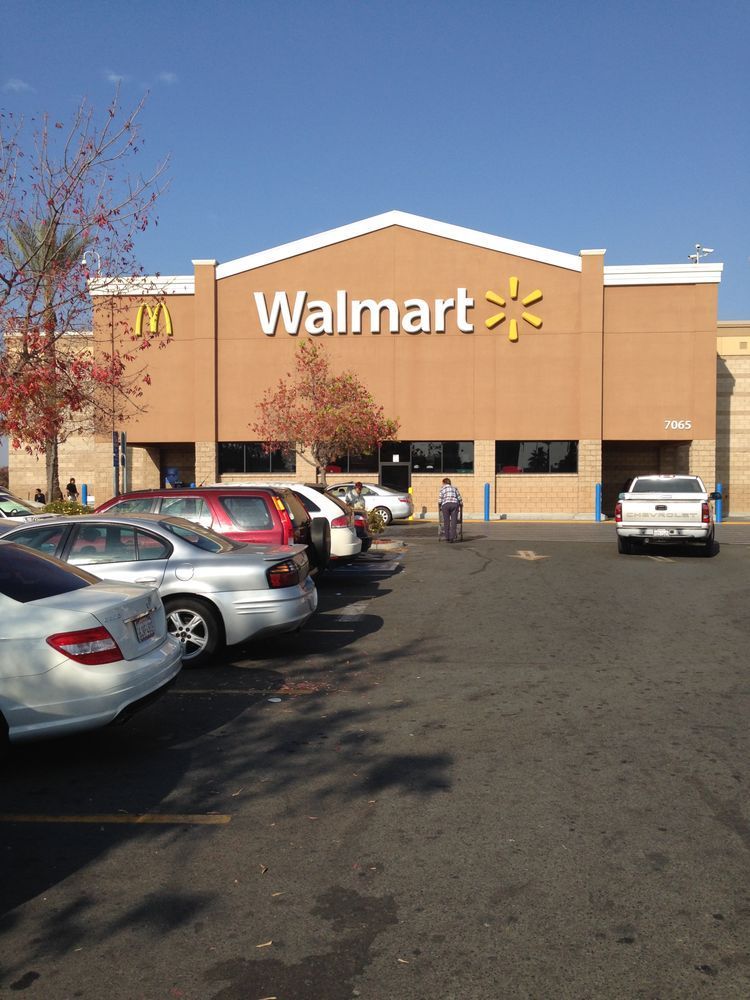 A walmart store with cars parked in front of it