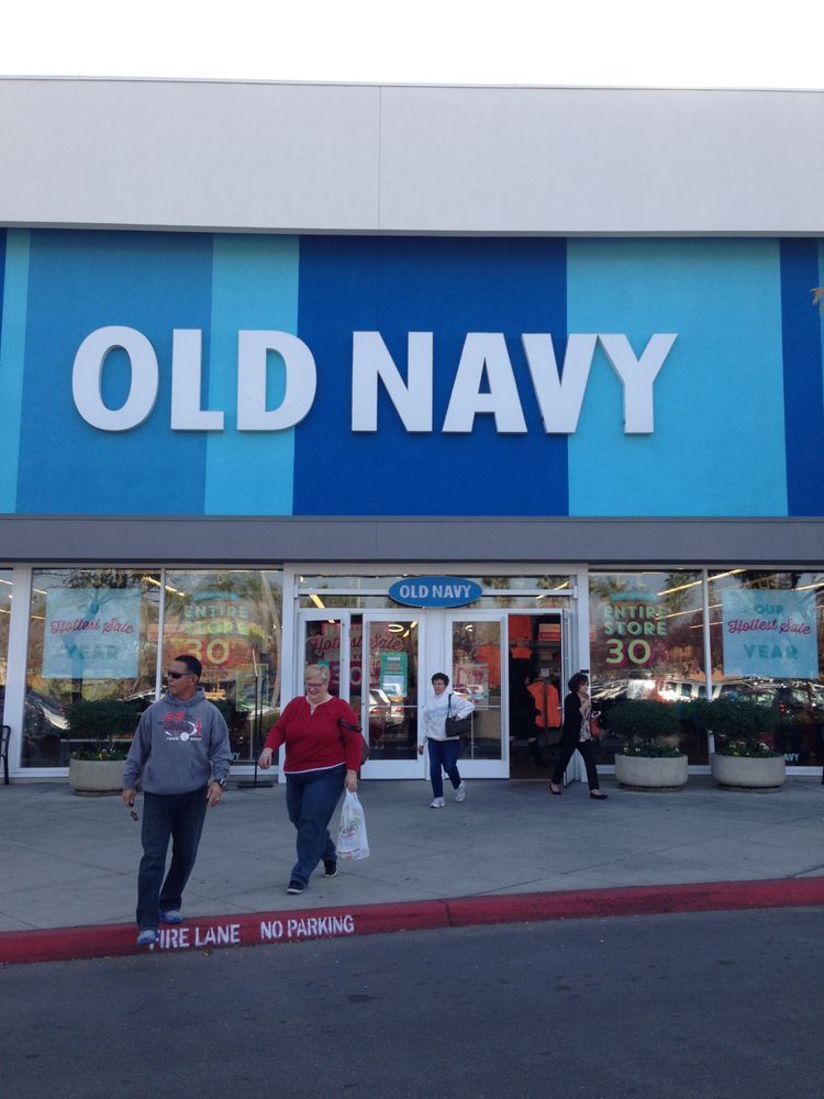 People walking in front of an old navy store