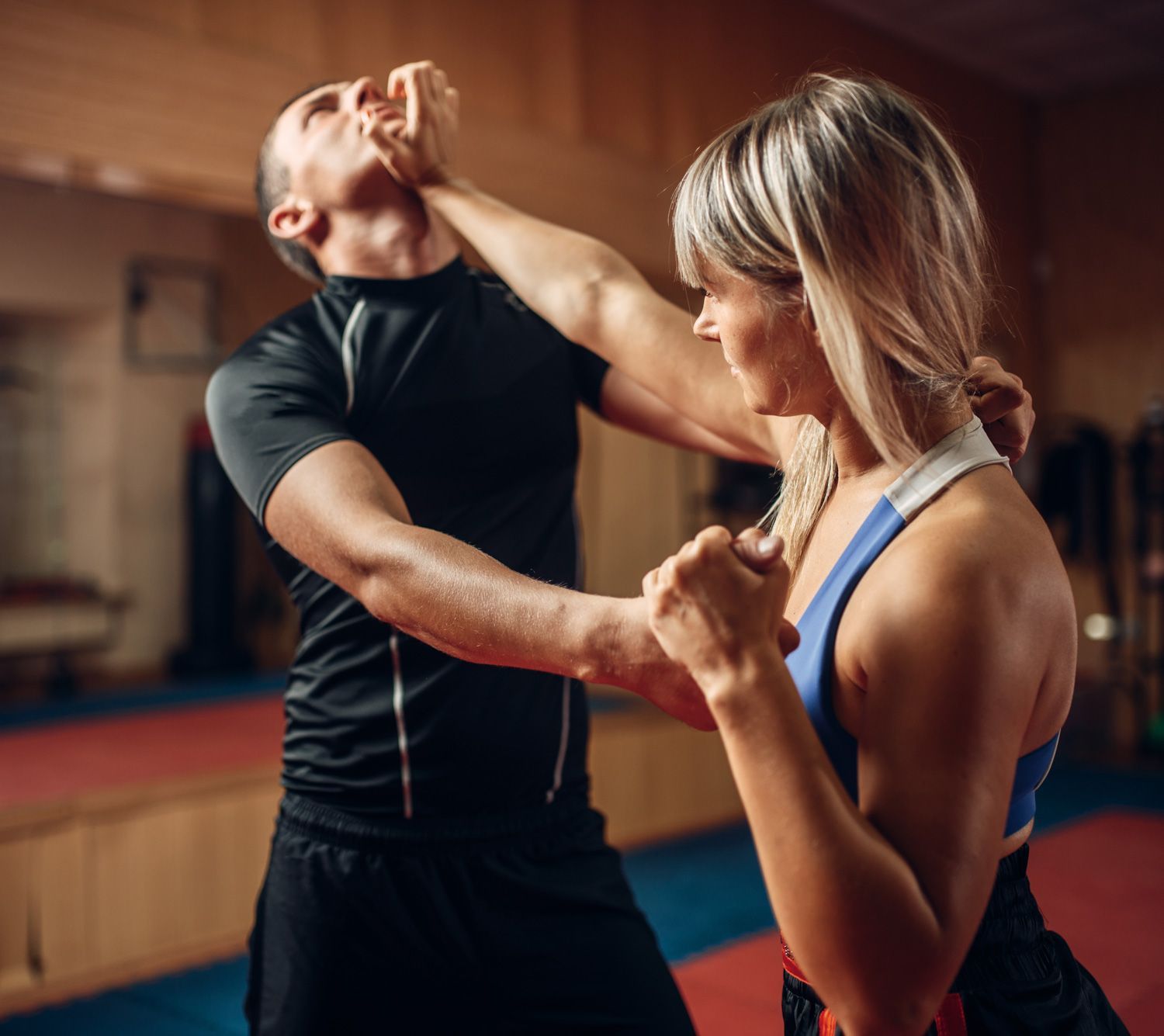Female person on self-defense workout with trainer