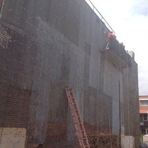 A ladder is leaning against the side of a building.
