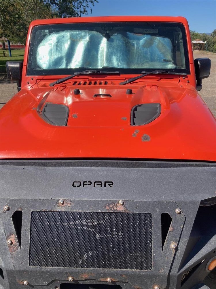 A red jeep with the word opar on the hood