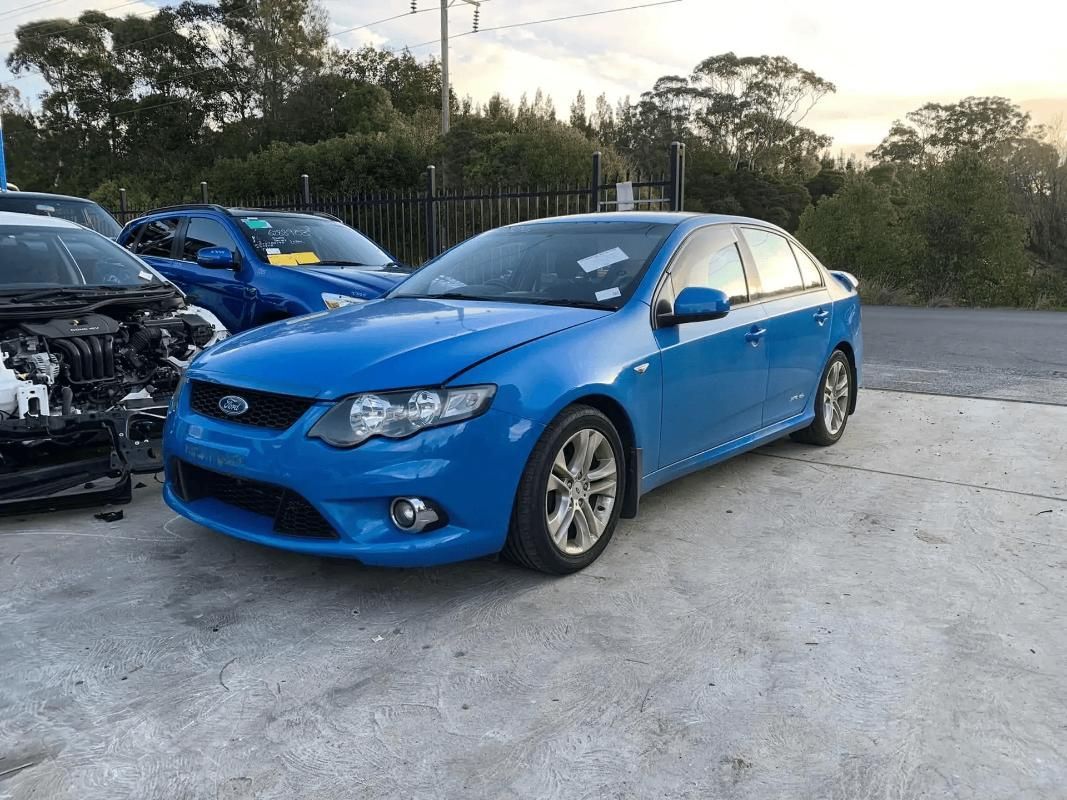 Blue Ford Sedan Parked in An Outdoor Lot — Jap Performance T/A All Tuggerah City Auto Dismantlers in Gosford, NSW
