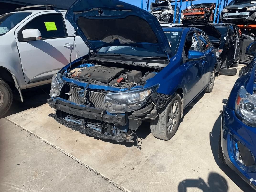 Blue Car with Front-End Damage in A Junkyard Setting — Jap Performance T/A All Tuggerah City Auto Dismantlers in Gosford, NSW