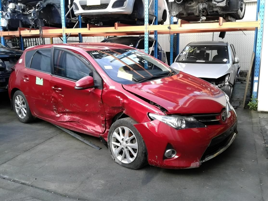 Red Car in A Junkyard with Side and Front-End Damage — Jap Performance T/A All Tuggerah City Auto Dismantlers in Hornsby, NSW