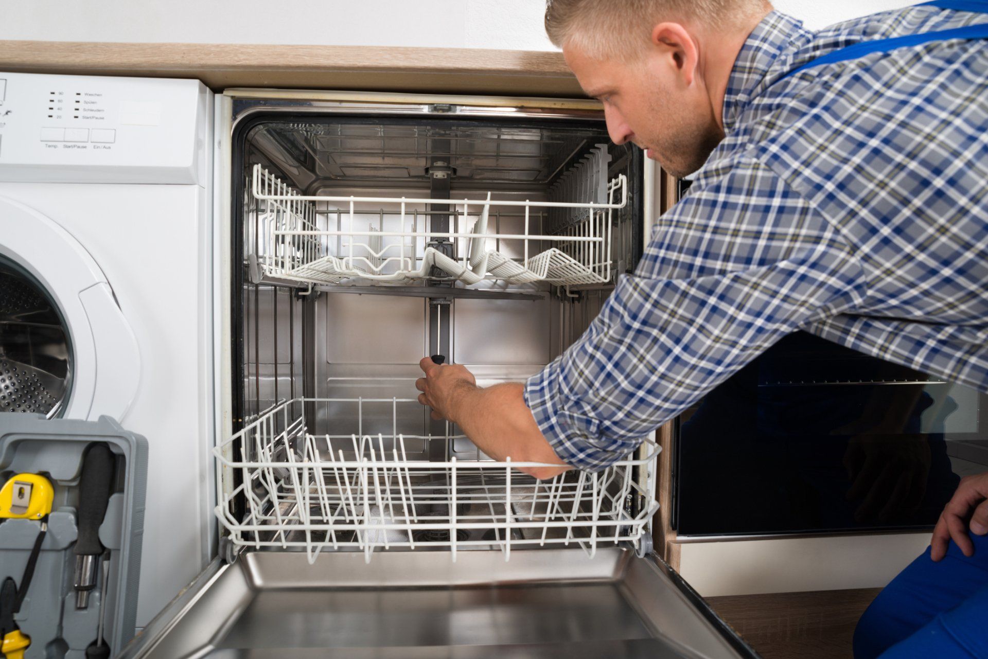 Leak in the Unit  — Open Dishwasher With Clean Dishes at Home Kitchen in Fort Worth, Tx
