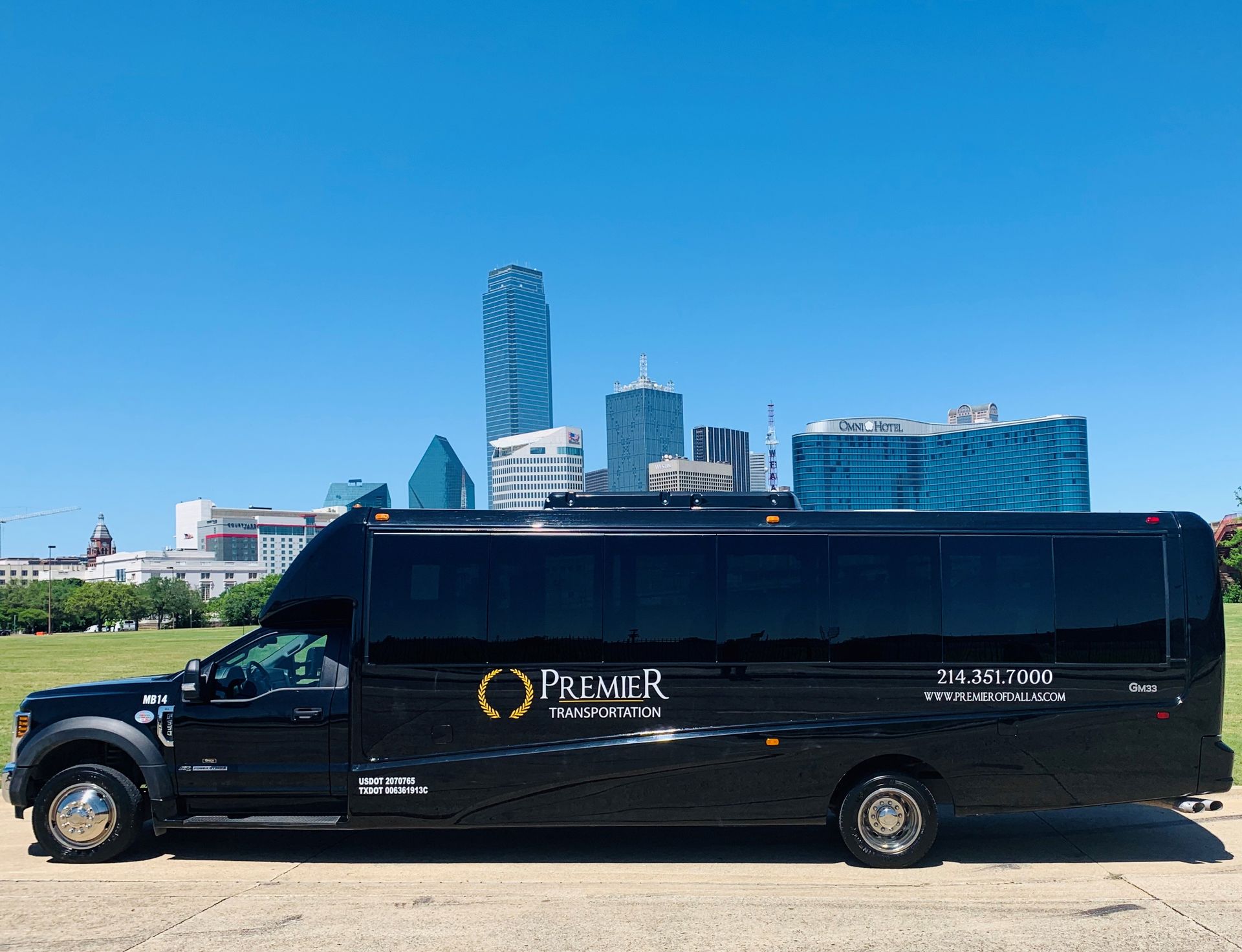 premier's black shuttle bus is parked in front of a city skyline