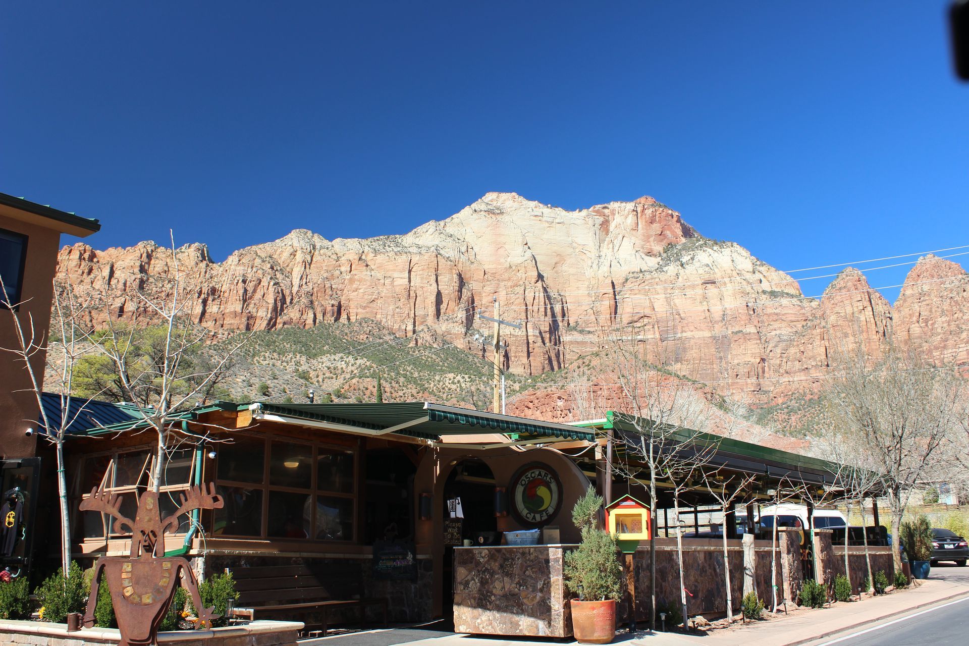 A restaurant with a lot of trees in front of it