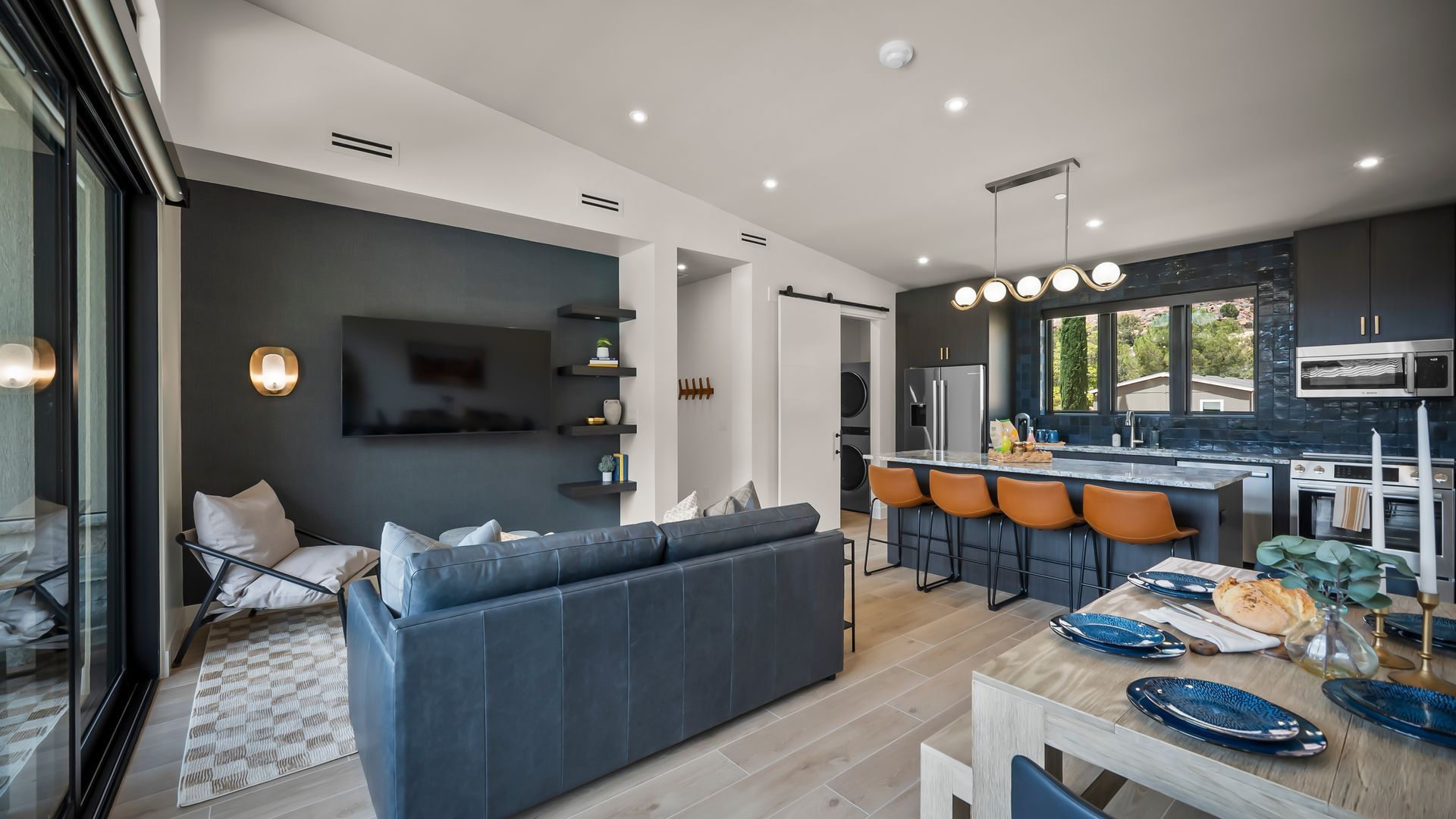 An artist 's impression of a living room and kitchen in a house.