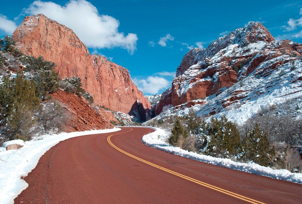 A road in the desert with mountains in the background.