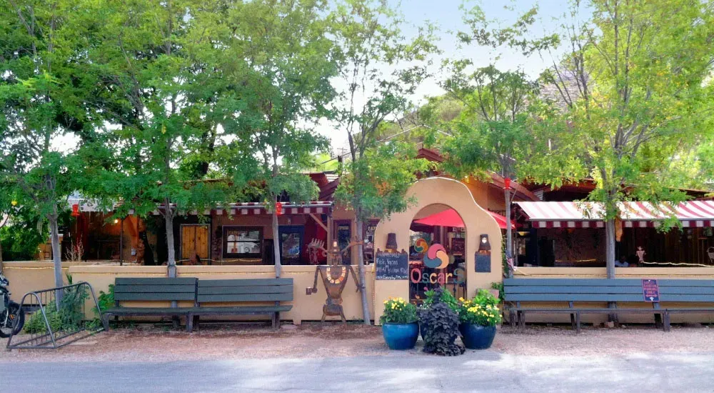 A restaurant with a lot of trees in front of it