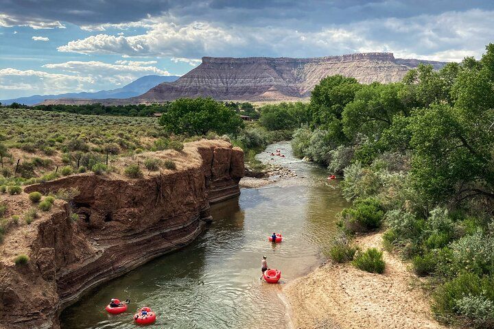 A group of people are tubing down a river.