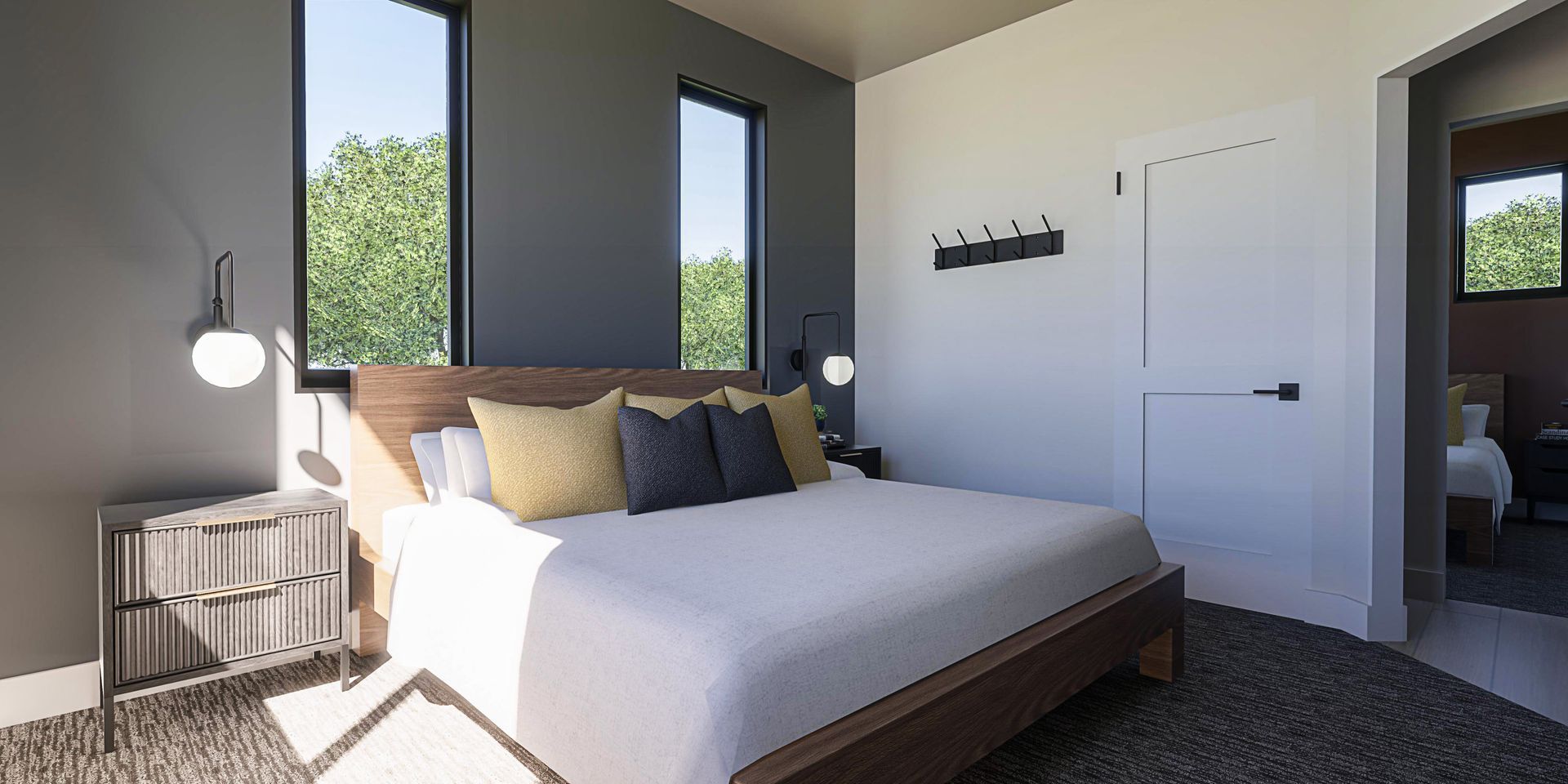 A bedroom with a large bed and two windows.