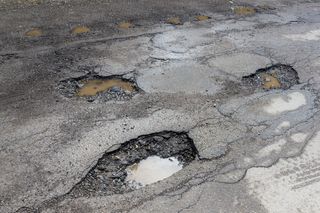 Asphalt Repair — Potholes On A Paved Road in Warsaw, IN