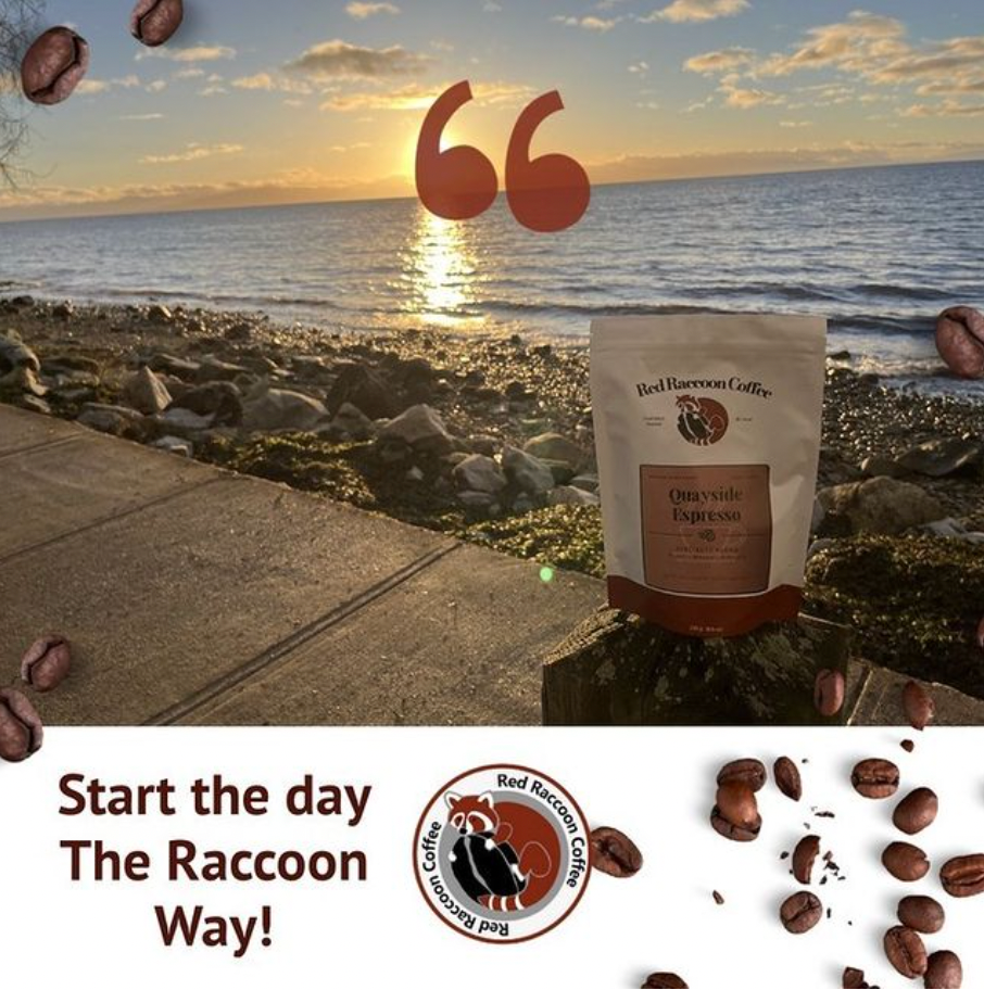 Bag of coffee by the beach at sunrise with scattered coffee beans.