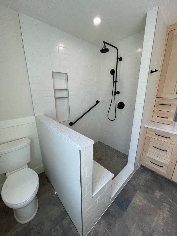 Stylish tile bath: clean white, sleek tub, ambient lighting