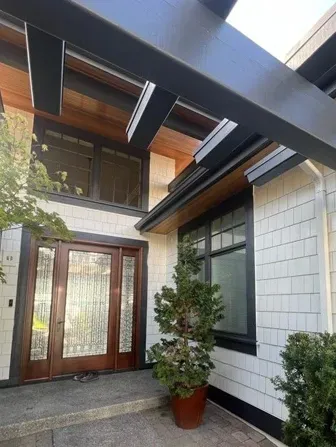 The front door of a house with a potted plant in front of it.