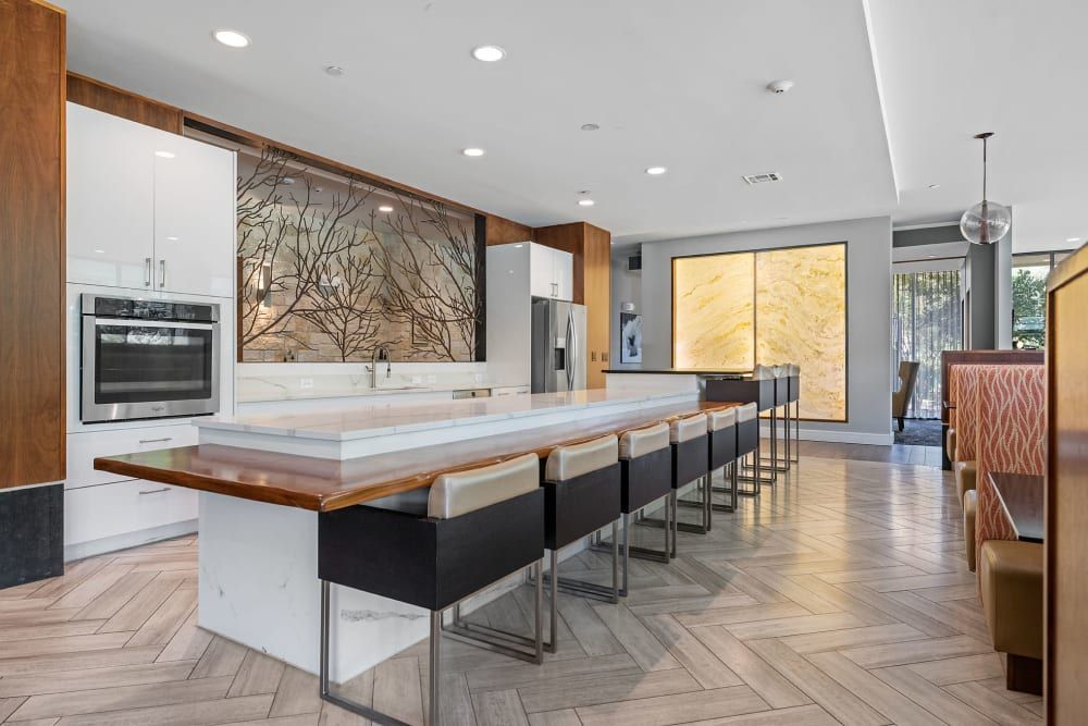 A large kitchen with a long table and chairs at Water's Edge.