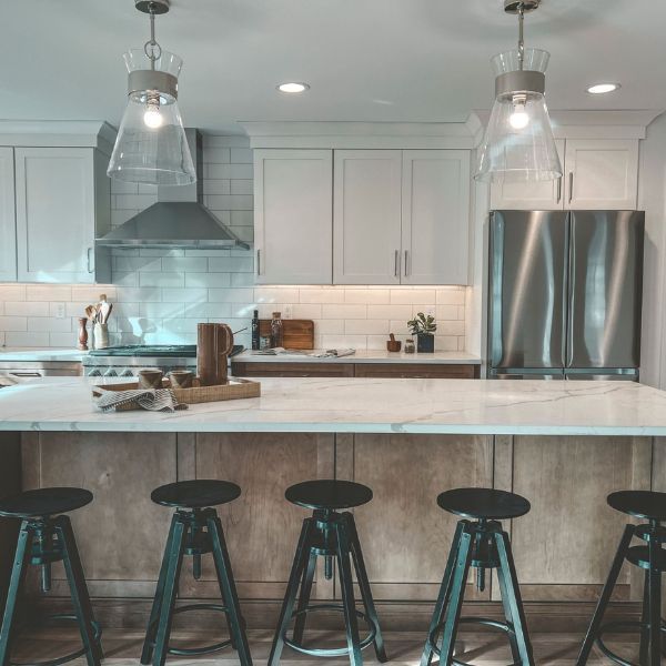 A kitchen with a large island and stools