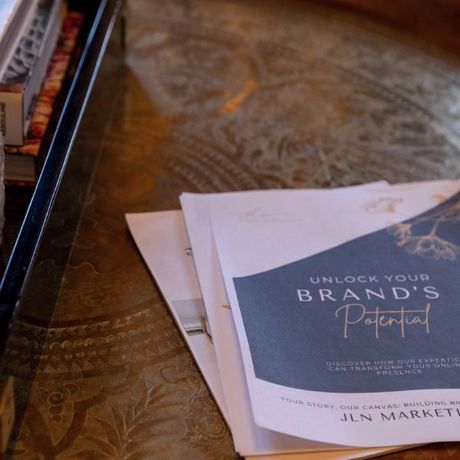 A book titled unlock your brand 's potential sits on a table