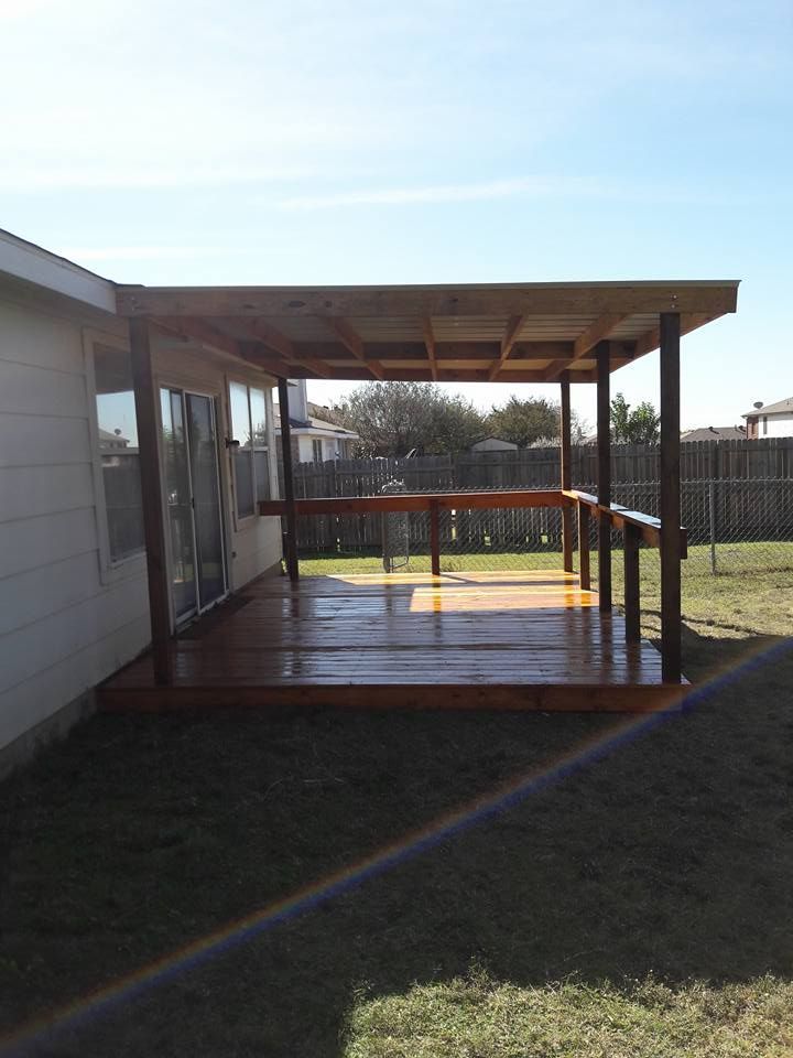 A house with a wooden deck in front of it