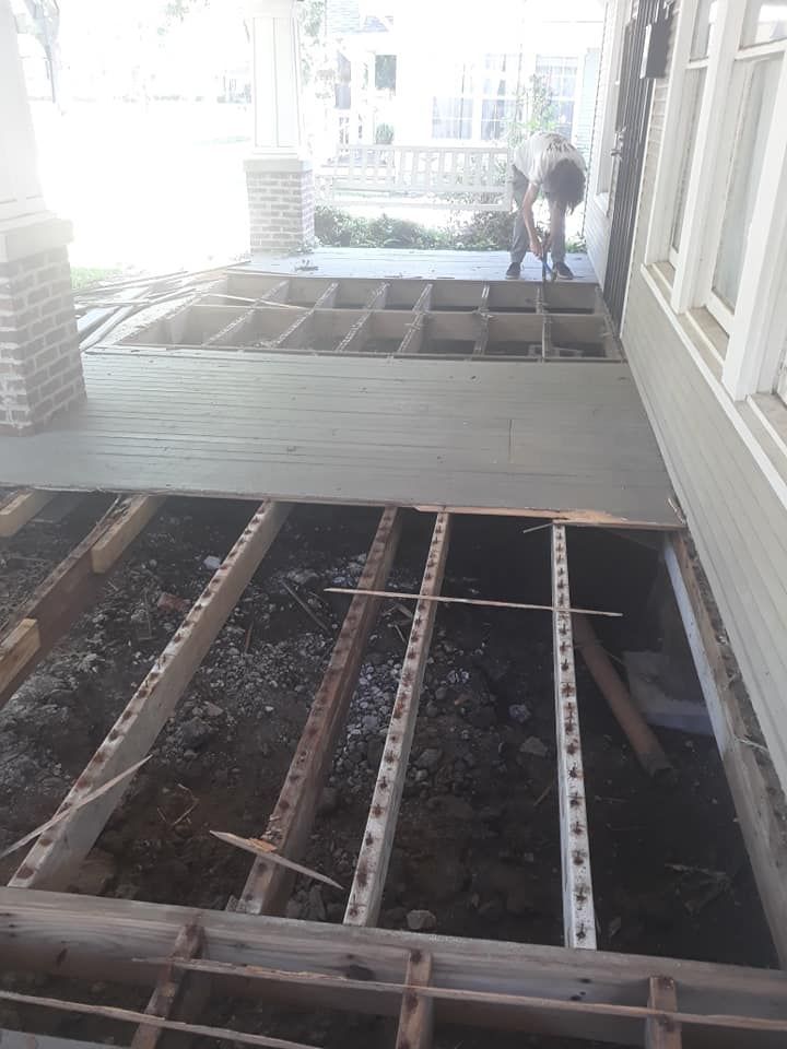 A man is working on the floor of a house.