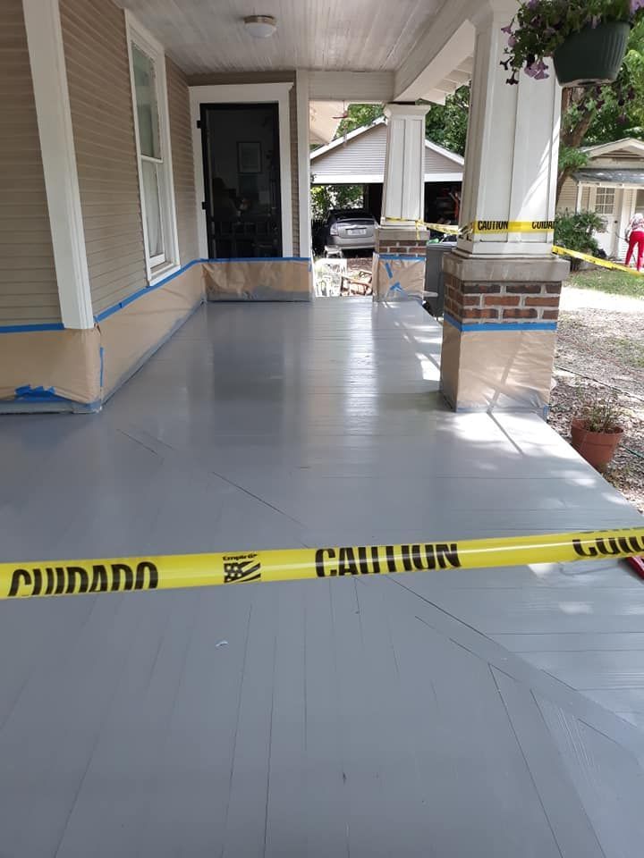 A porch with a yellow tape that says caution on it