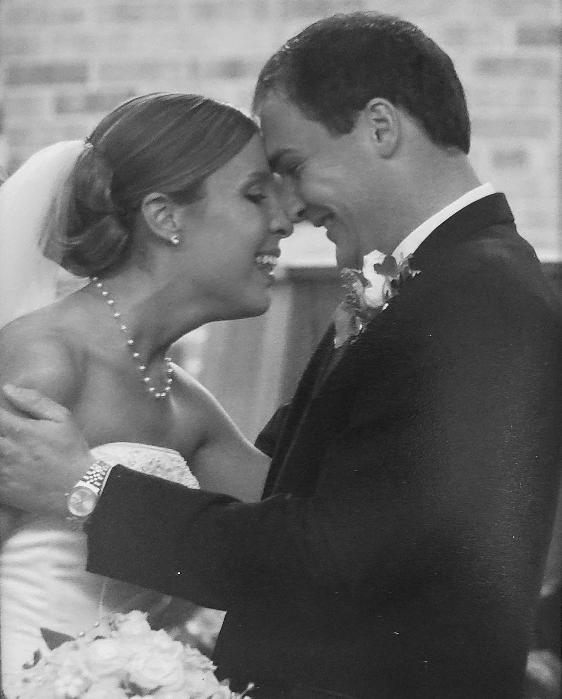 black and white image of the couple on their wedding day right after they got married with pure joy 