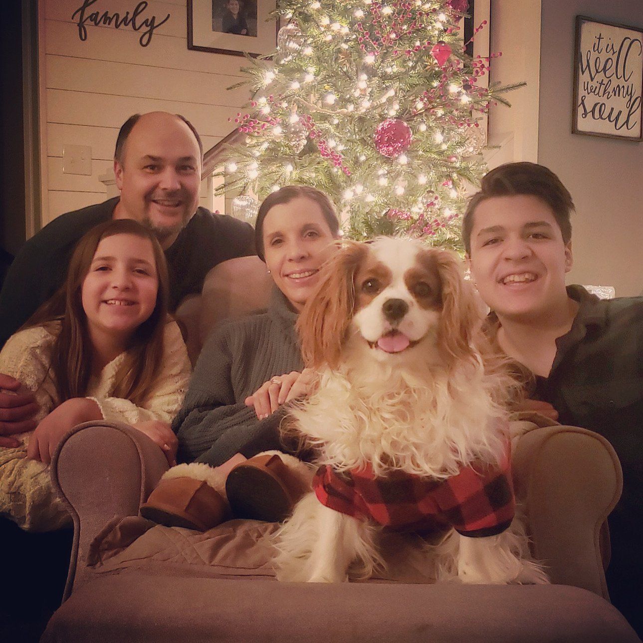 family in front of chhristmas tree at night: Cavalier, amy, randy, mason and ella.