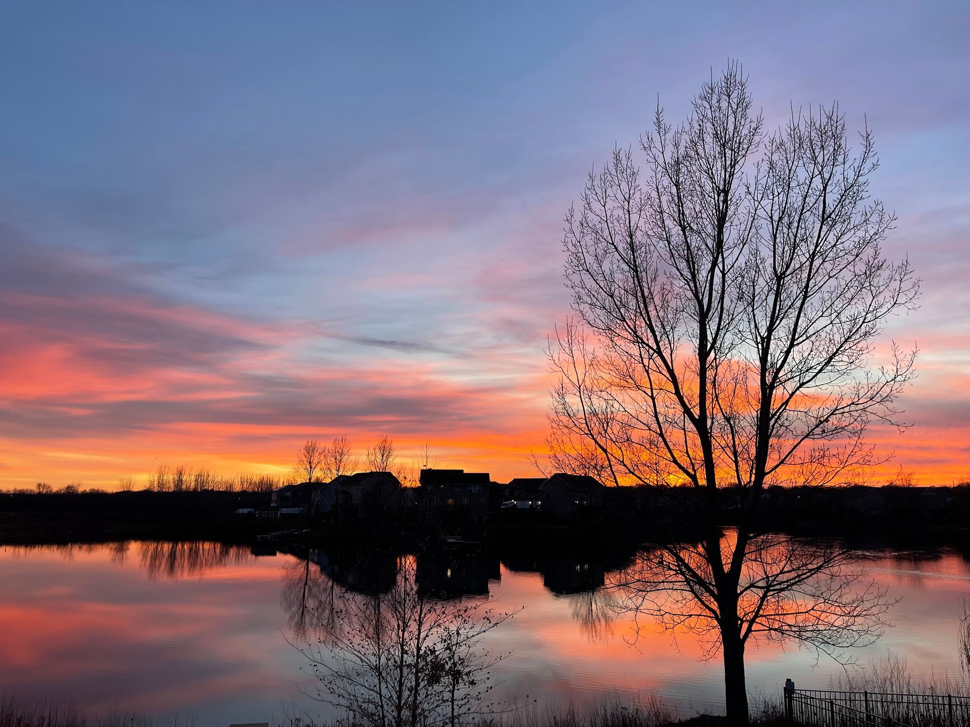 Beautiful sunset sky filled with purples, blue, orange and yellow in vibrant shades over a lake.