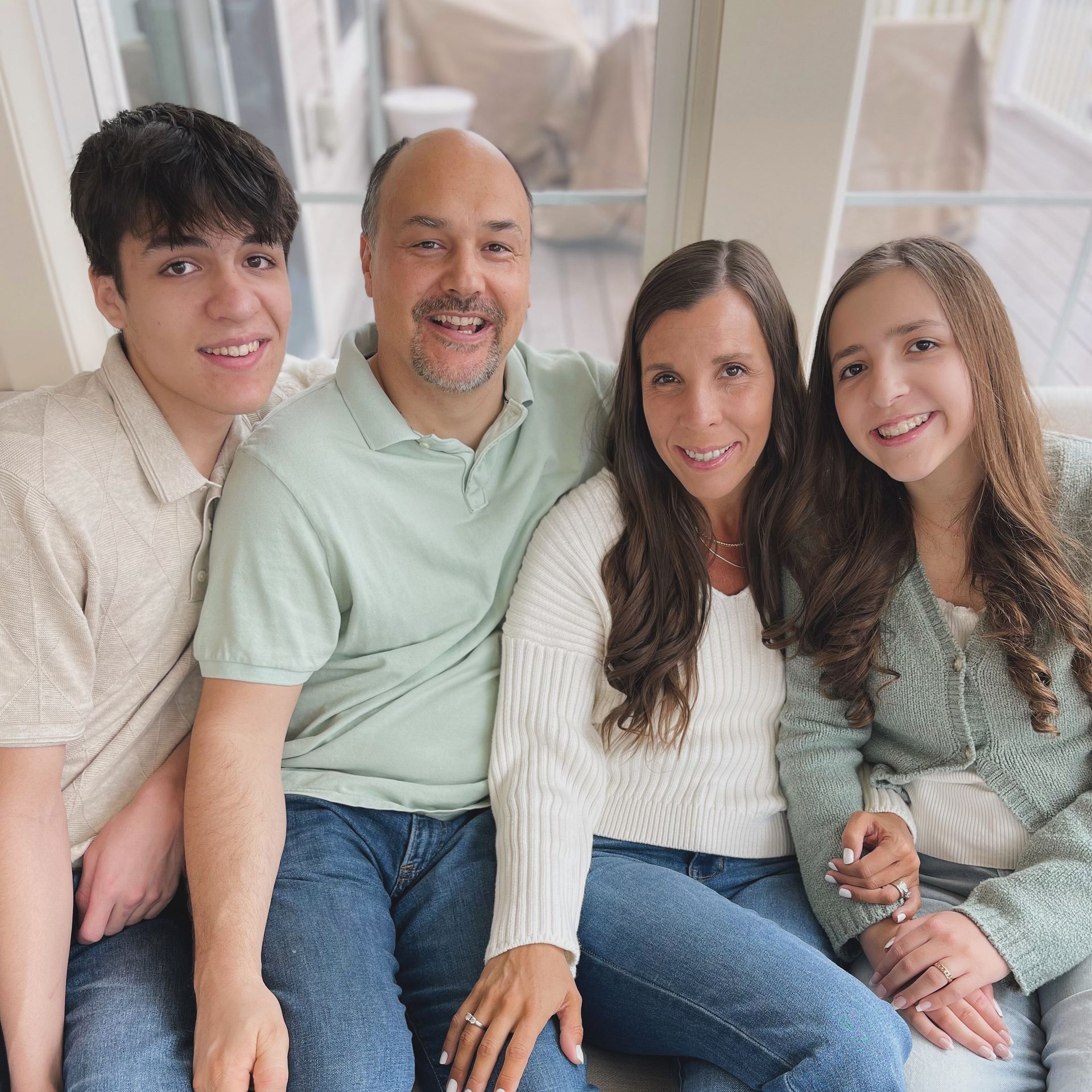 The family in a closer photo smiling for the camera.