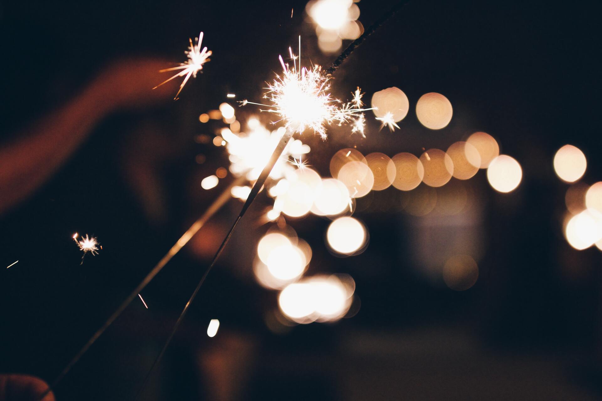 new years sparklers on long stick with dark background