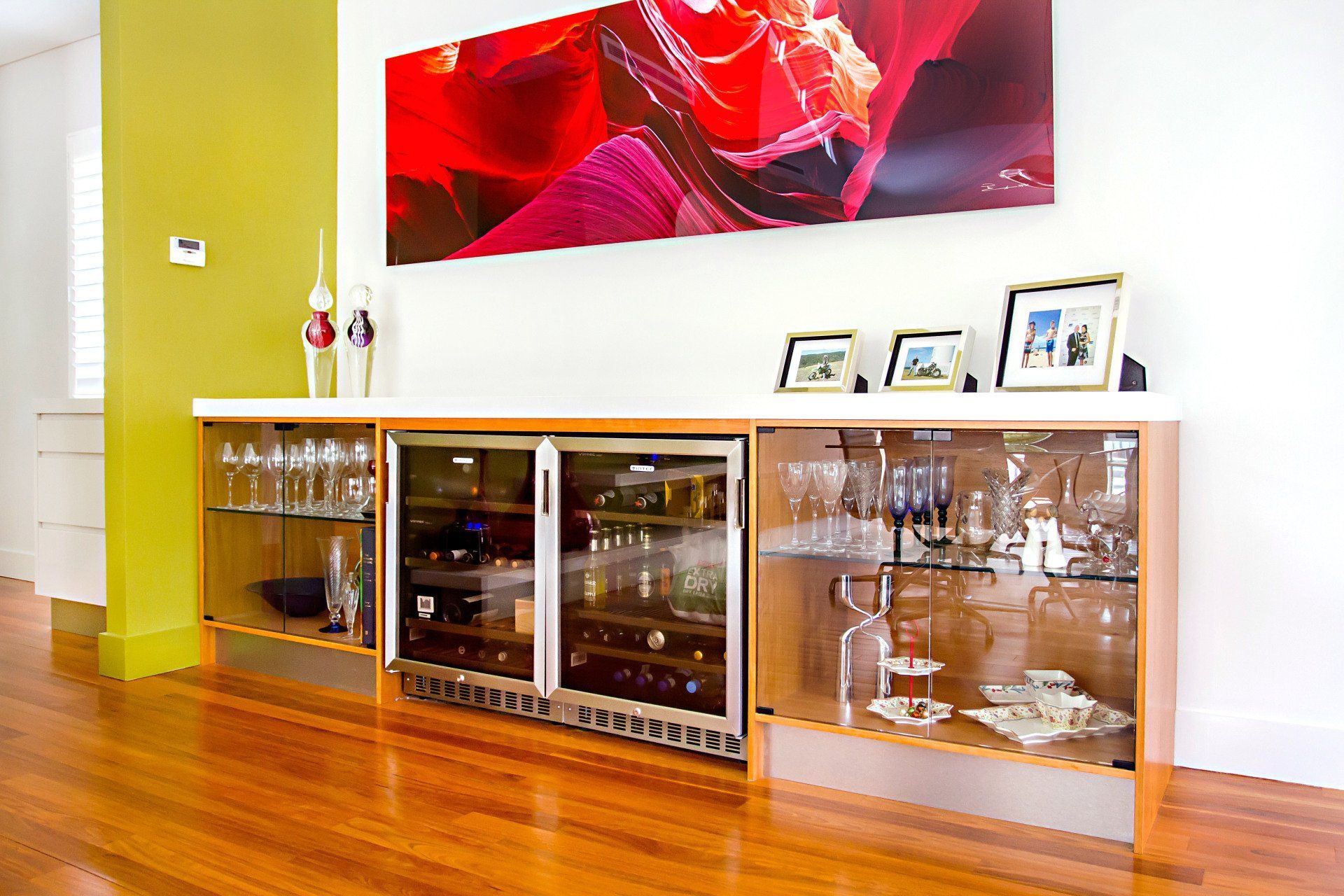 A Dining Room with A Wine Cooler and A Picture on The Wall — Marlix Custom Timber Furniture Design and Joinery in Unanderra, NSW