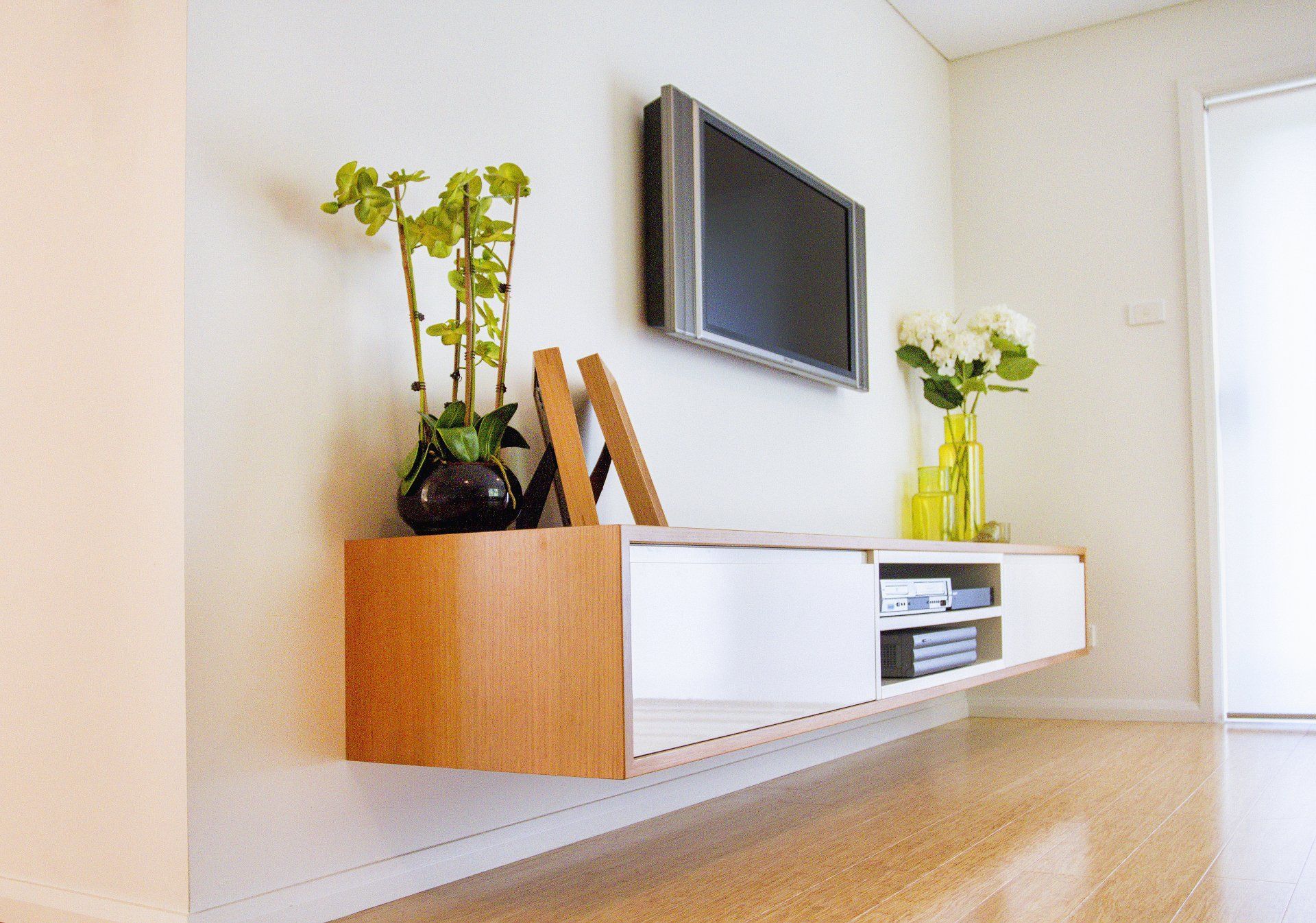 A Living Room with A Floating Entertainment Center and A Flat Screen Tv — Marlix Custom Timber Furniture Design and Joinery in Unanderra, NSW