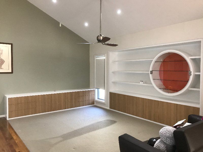 A Living Room with A Couch and A Ceiling Fan — Marlix Custom Timber Furniture Design and Joinery in Unanderra, NSW