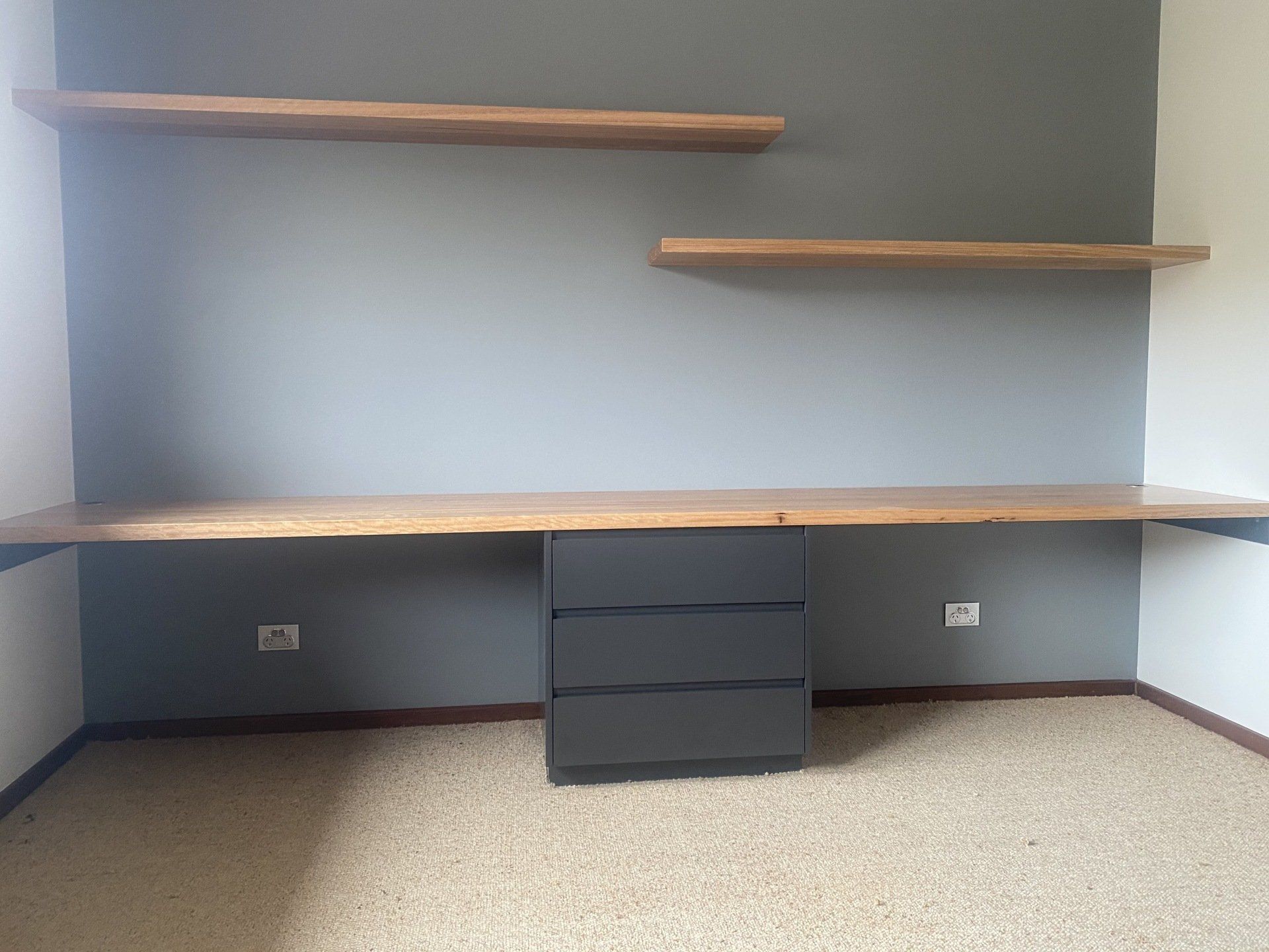 An Empty Room with A Desk and Shelves on The Wall — Marlix Custom Timber Furniture Design and Joinery in Unanderra, NSW