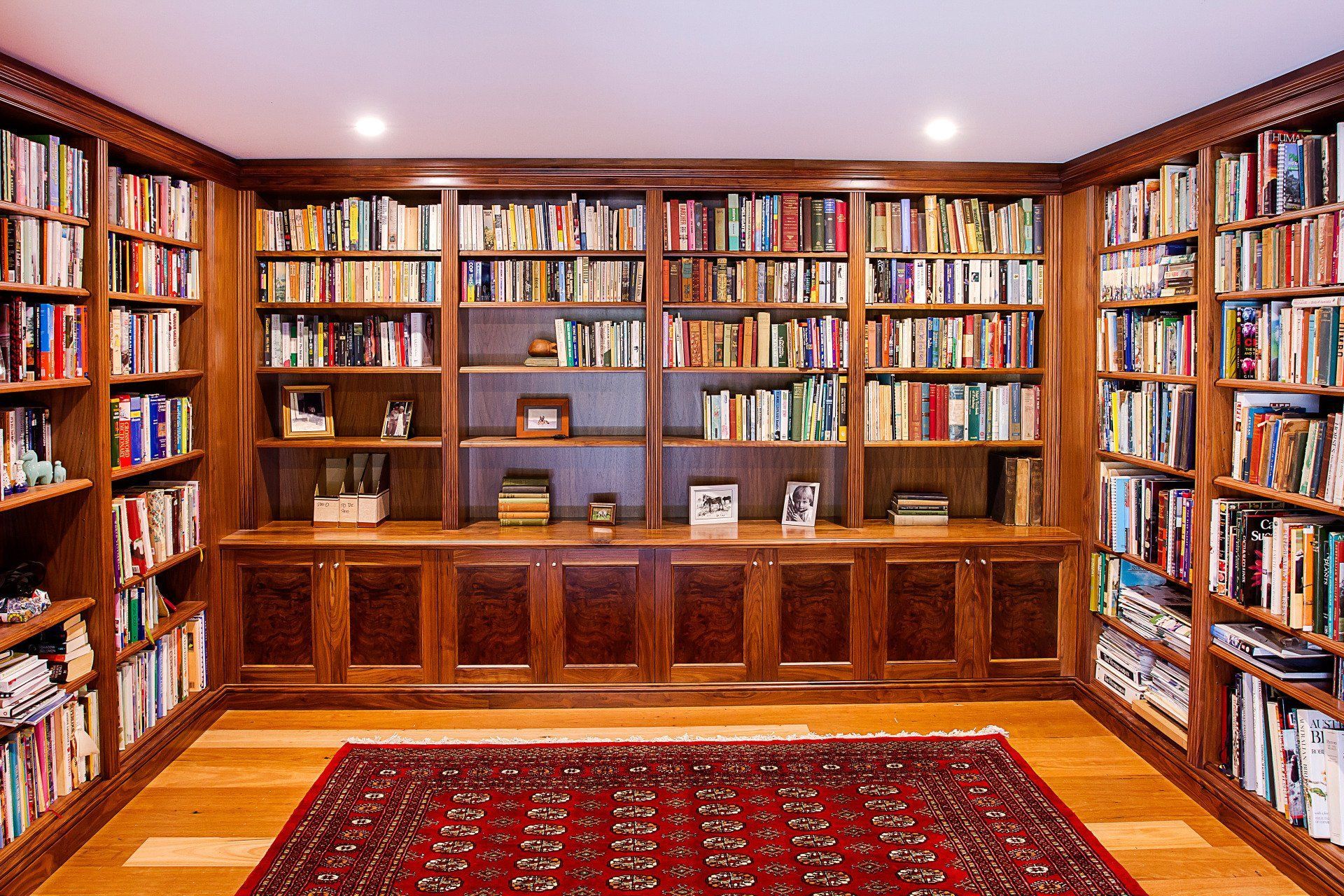 A Library Filled with Lots of Books and A Rug — Marlix Custom Timber Furniture Design and Joinery in Unanderra, NSW