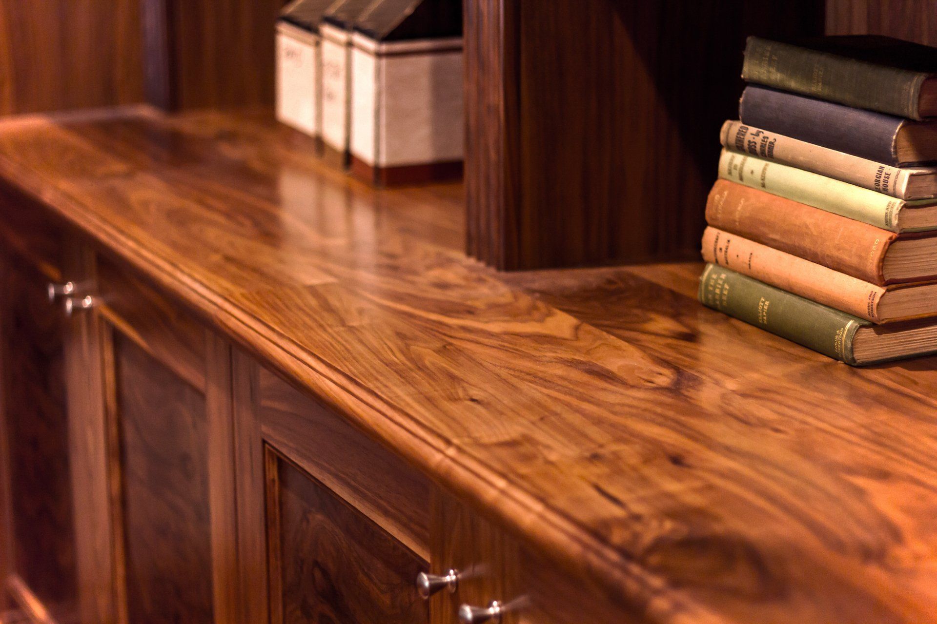 A Wooden Shelf with A Stack of Books on It — Marlix Custom Timber Furniture Design and Joinery in Unanderra, NSW