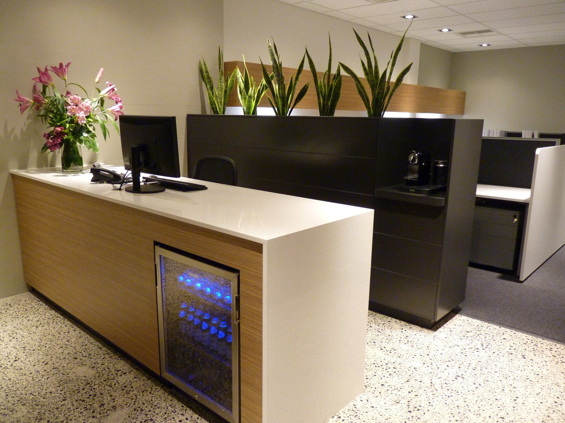 A Desk with A Computer and A Refrigerator Underneath It — Marlix Custom Timber Furniture Design and Joinery in Unanderra, NSW