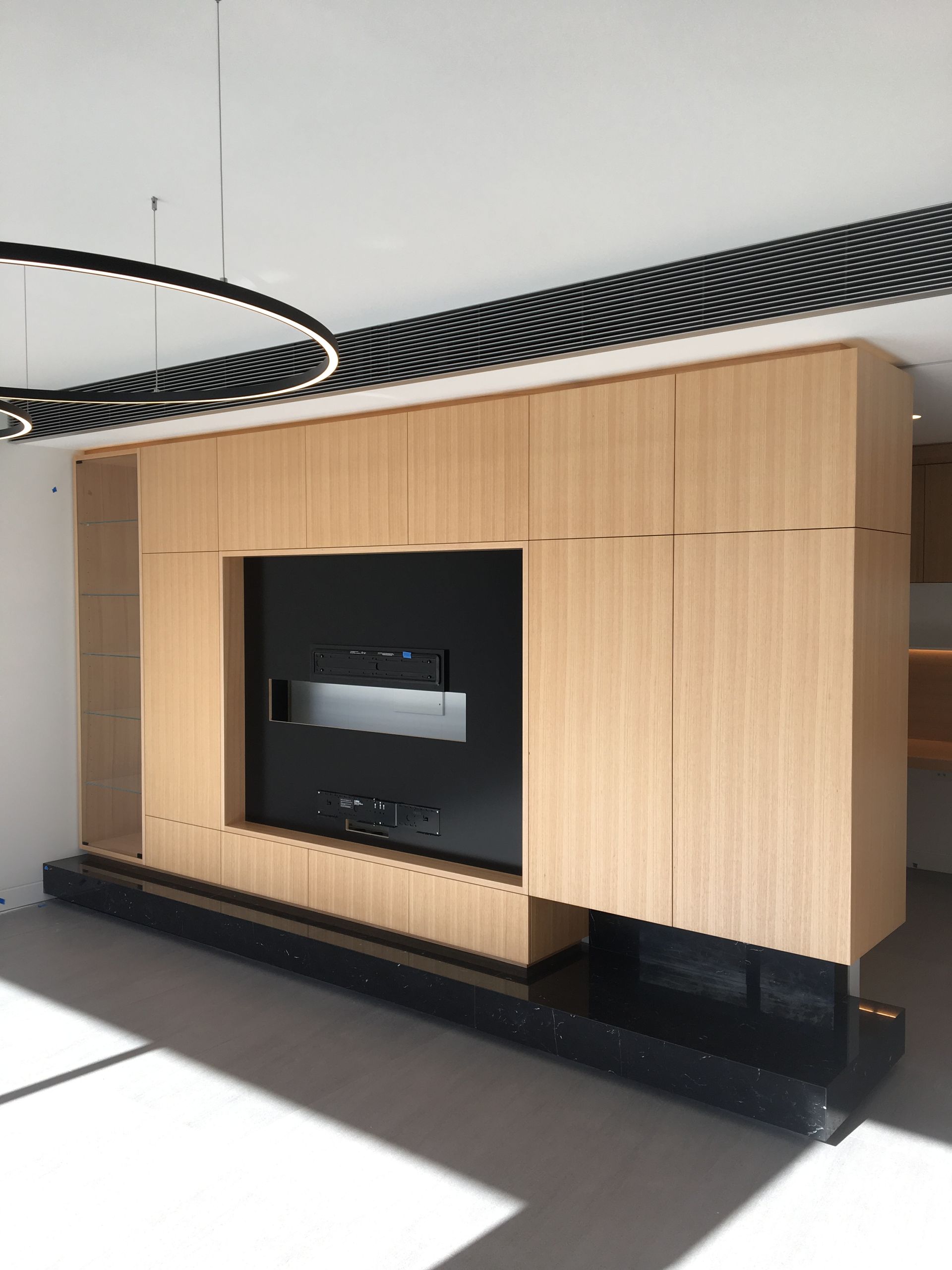 A Living Room with Wooden Cabinets and A Flat Screen Tv — Marlix Custom Timber Furniture Design and Joinery in Unanderra, NSW