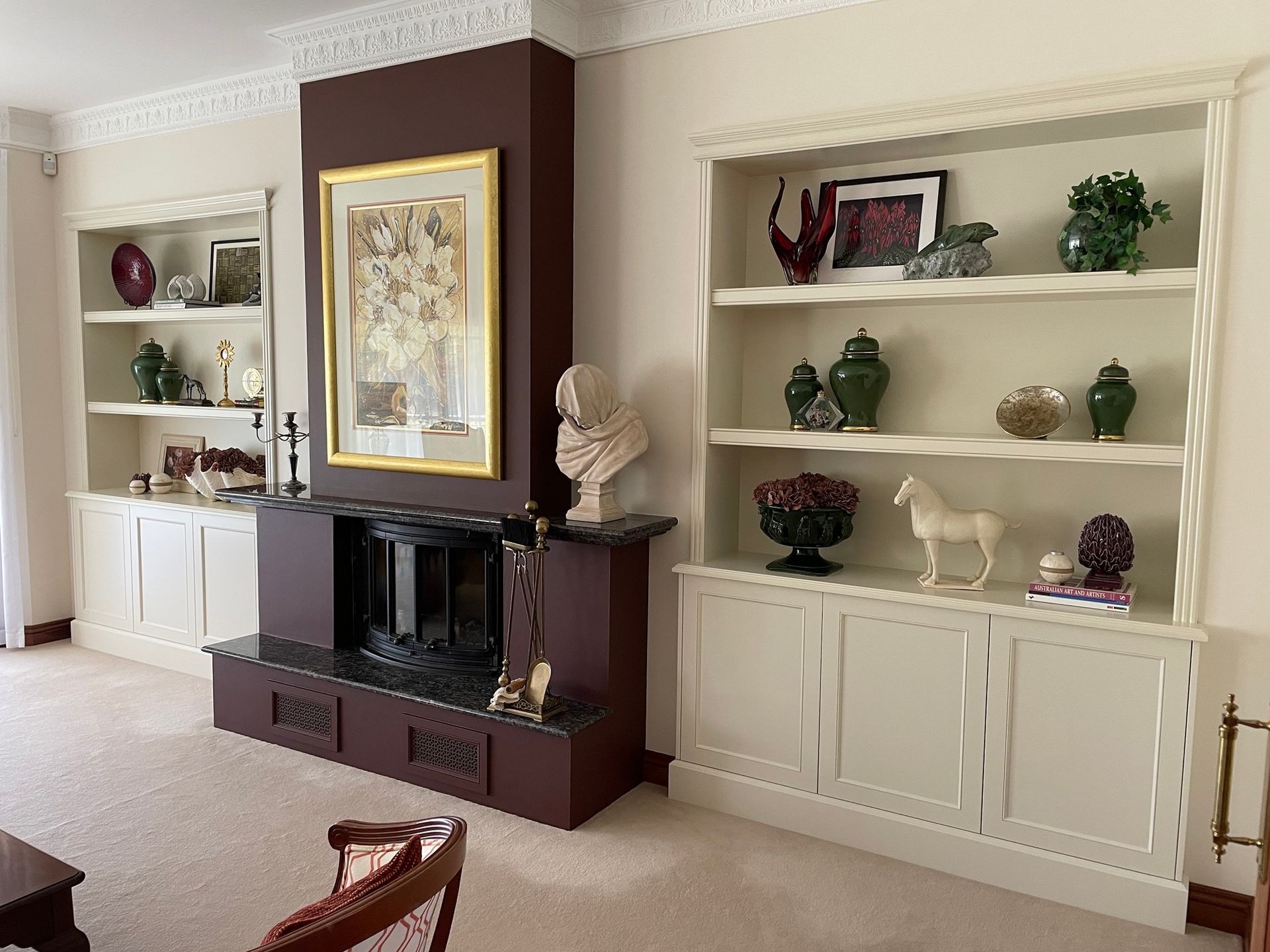 A Living Room with A Fireplace and Lots of Shelves — Marlix Custom Timber Furniture Design and Joinery in Unanderra, NSW