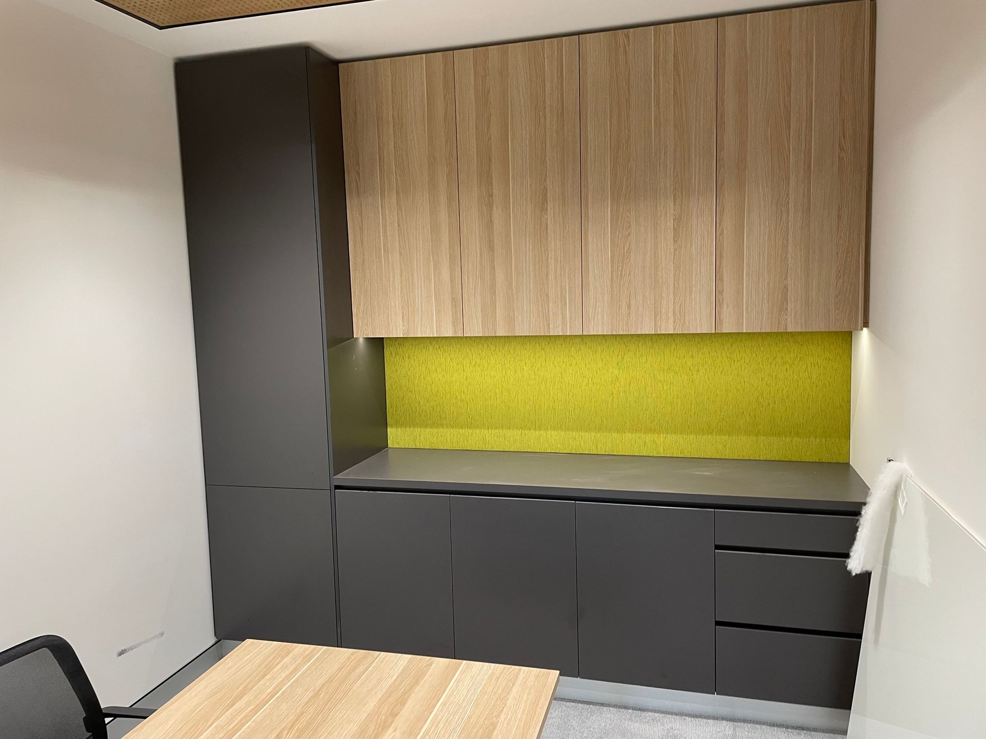 A Kitchen with A Table and Chairs and A Yellow Wall — Marlix Custom Timber Furniture Design and Joinery in Unanderra, NSW