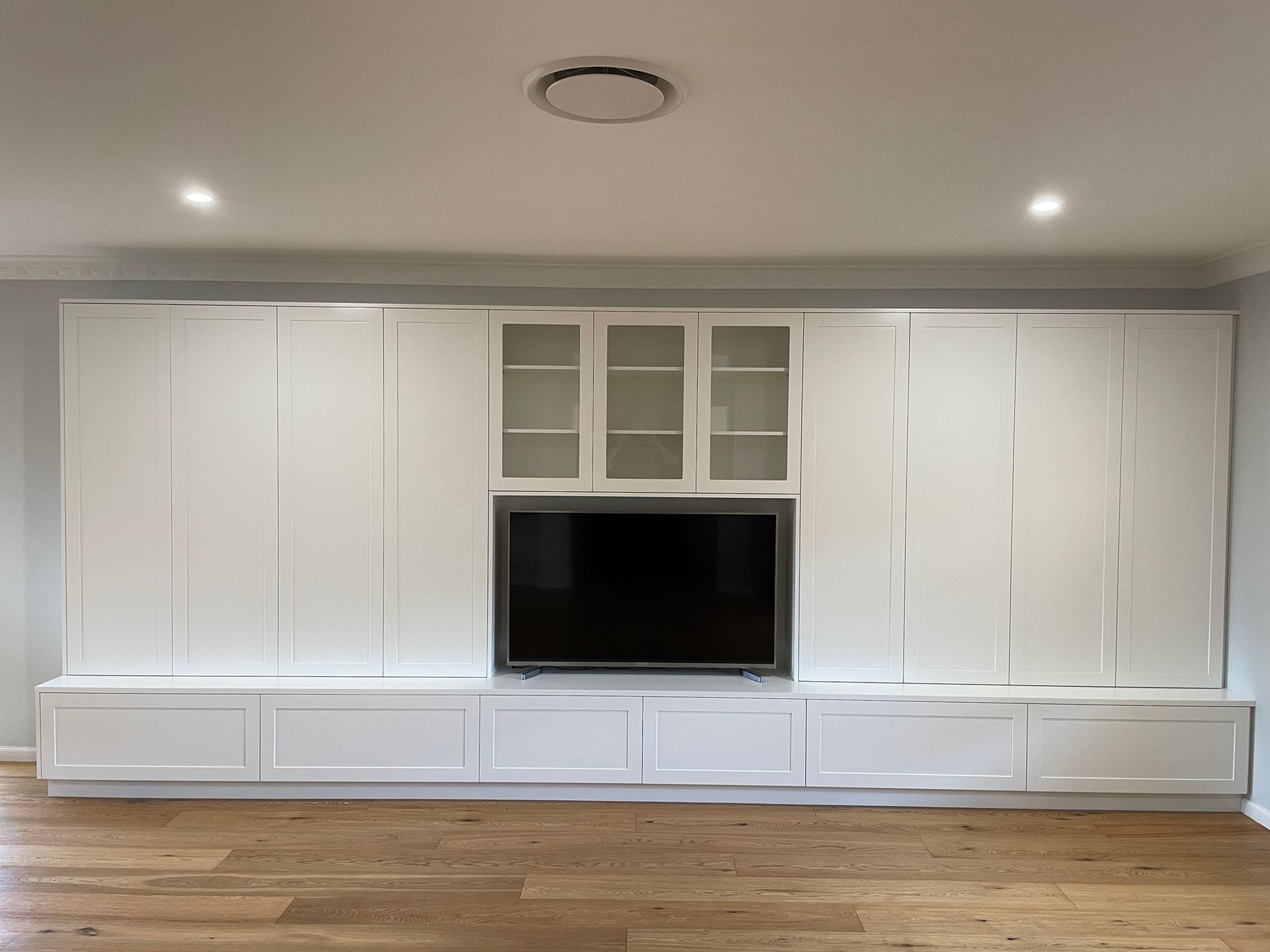 A Living Room with White Cabinets and A Flat Screen Tv — Marlix Custom Timber Furniture Design and Joinery in Unanderra, NSW