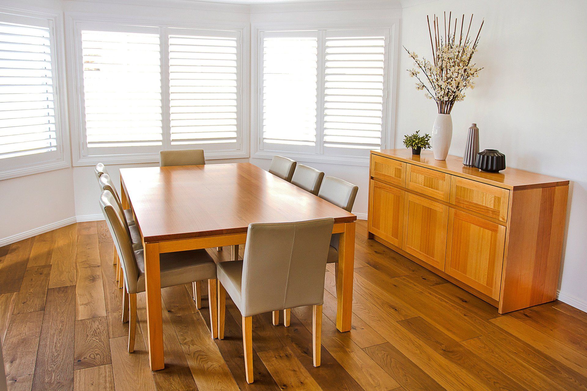 A Dining Room With A Long Wooden Table And Chairs — Marlix Custom Timber Furniture Design and Joinery in Unanderra, NSW