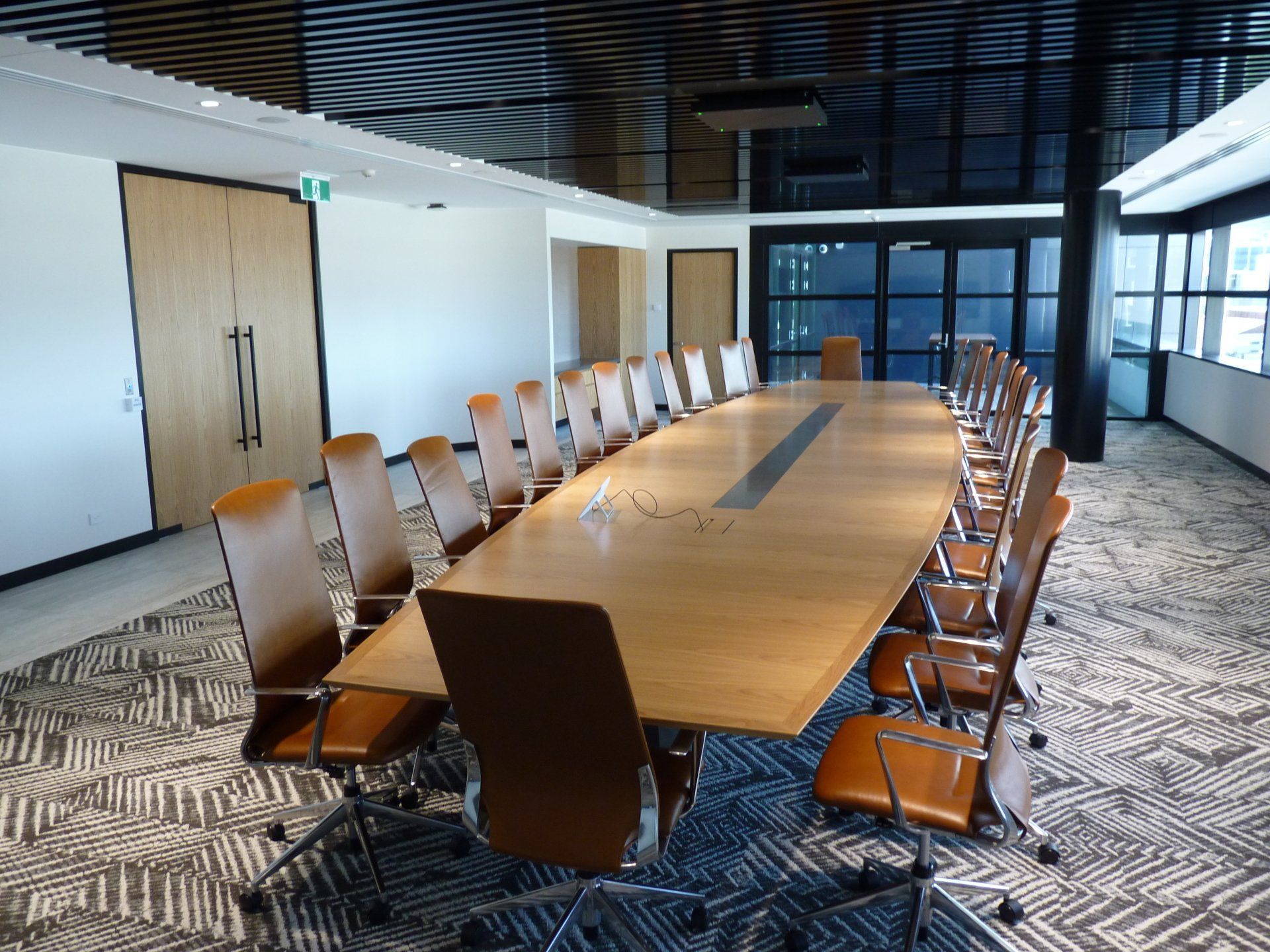 A Conference Room With A Long Table And Chairs — Marlix Custom Timber Furniture Design and Joinery in Unanderra, NSW