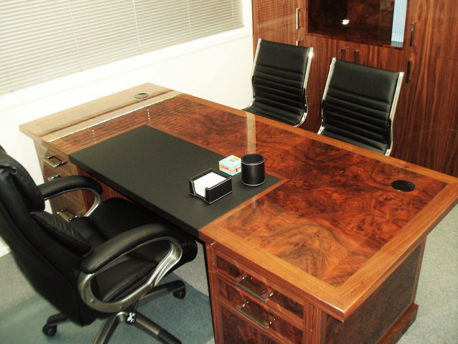 A Wooden Desk With A Black Chair In Front Of It — Marlix Custom Timber Furniture Design and Joinery in Unanderra, NSW