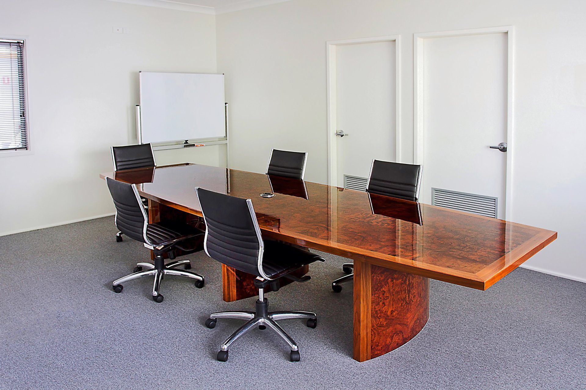 A Conference Room With A Long Wooden Table And Chairs — Marlix Custom Timber Furniture Design and Joinery in Unanderra, NSW