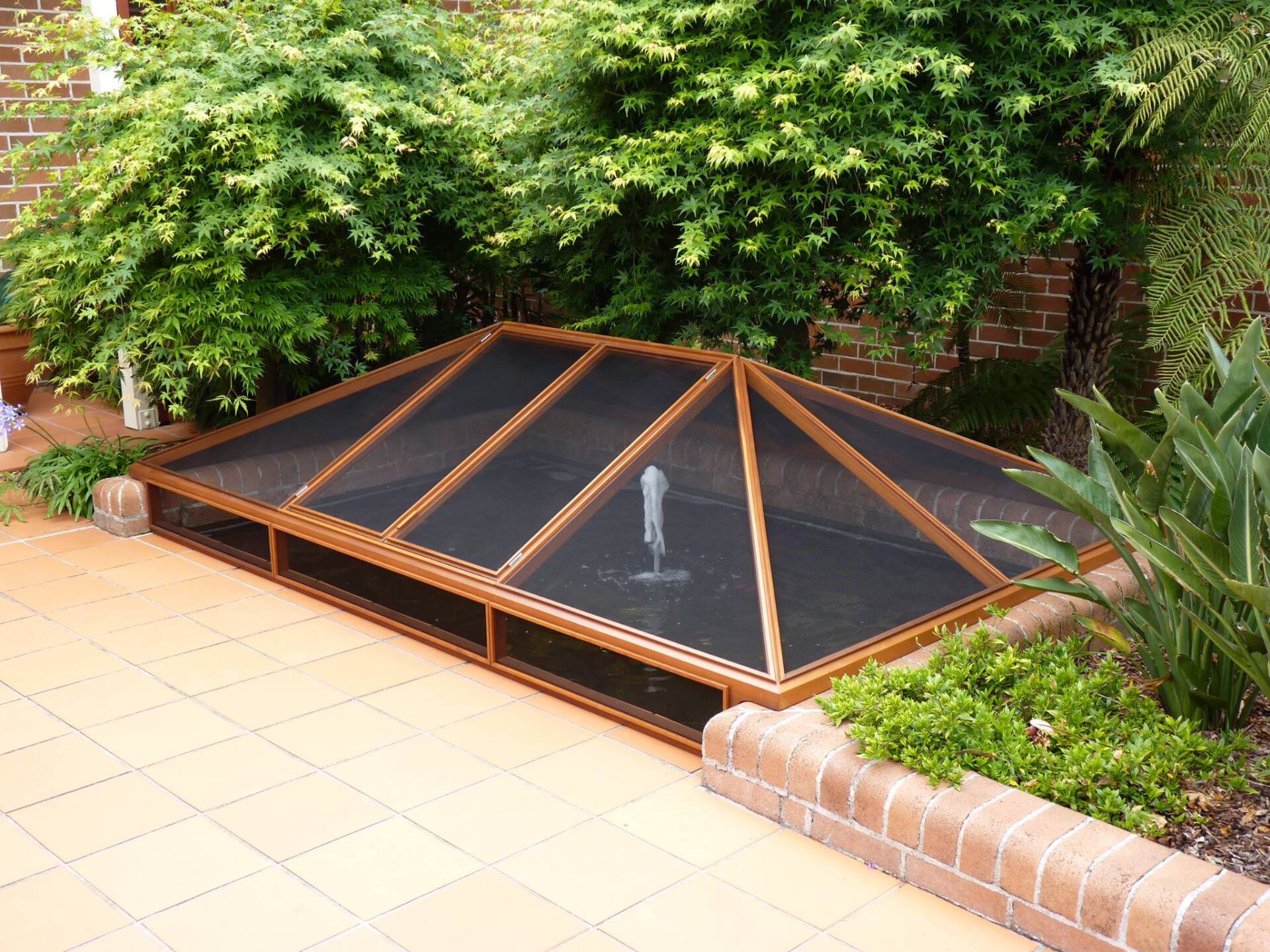 A Patio with A Fountain Under a Canopy — Marlix Custom Timber Furniture Design and Joinery in Unanderra, NSW