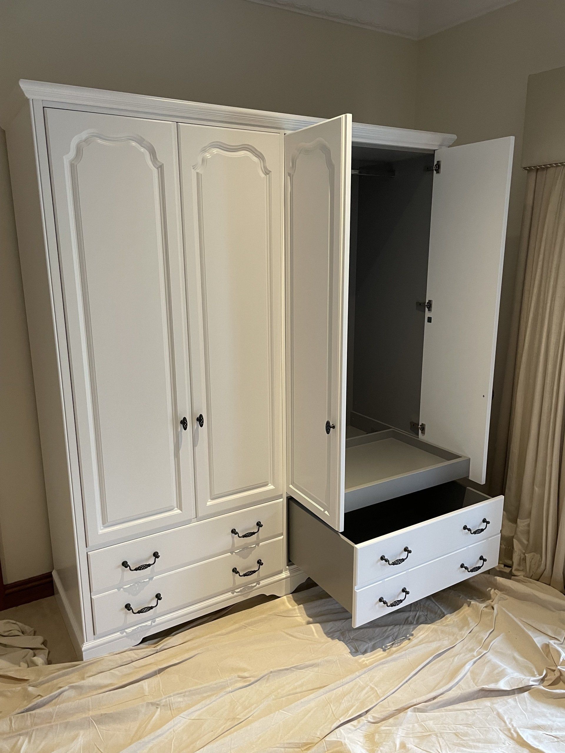 A White Wardrobe With Its Doors Open And Drawers — Marlix Custom Timber Furniture Design and Joinery in Unanderra, NSW