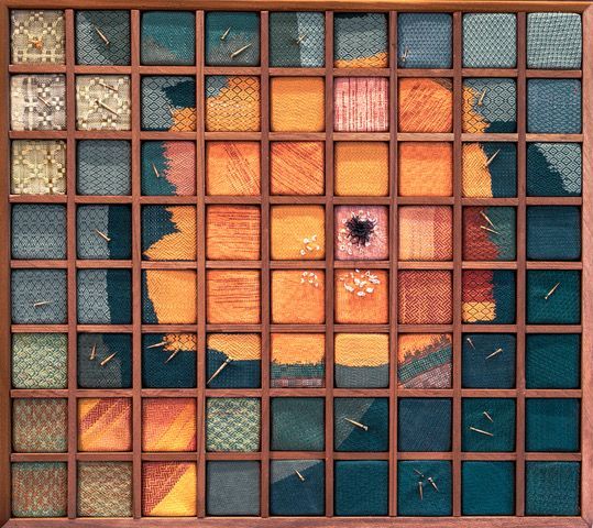 A weaving with a variety of colored squares